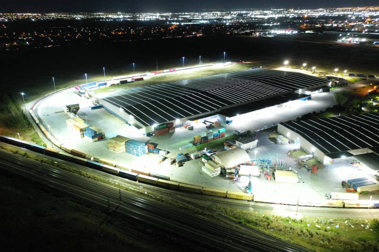 Birdseye view of a large warehouse with LED lighting around the entire site