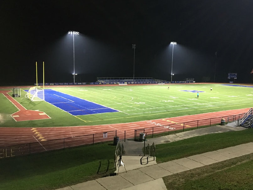 Sportsfield lit up by LED lights at night.