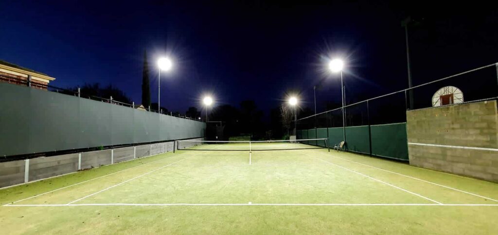 Grass court tennis courts with LED lights.